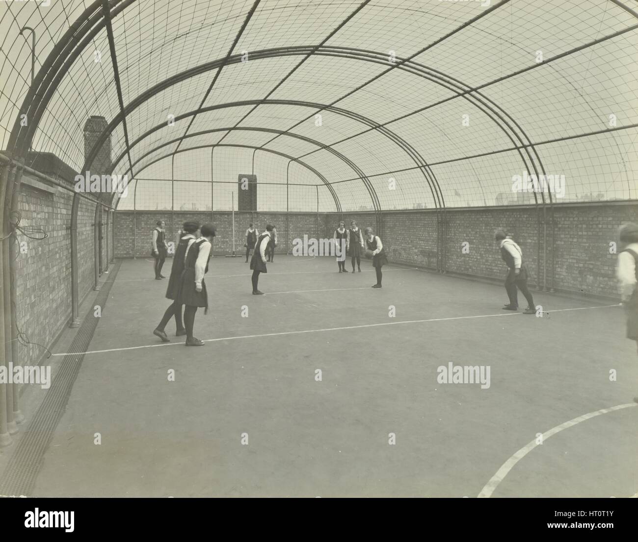 Girls playing netball on a roof playground, Barrett Street Trade School, London, 1927. Artist: Unknown. Stock Photo