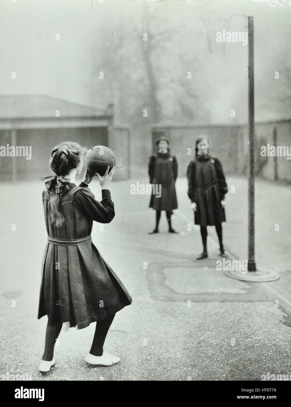 Girls playing netball, Chelsea Secondary School (Hortensia Road School), London, 1911. Artist: Unknown. Stock Photo