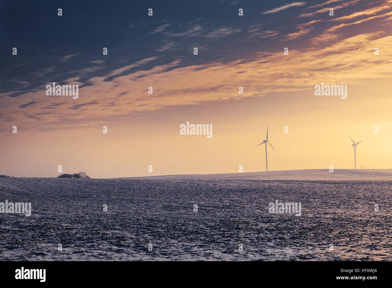 Modern wind turbines during wintertime on sunset Stock Photo