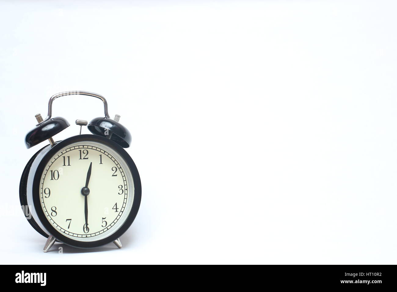 Retro alarm clock isolated on white background Stock Photo - Alamy