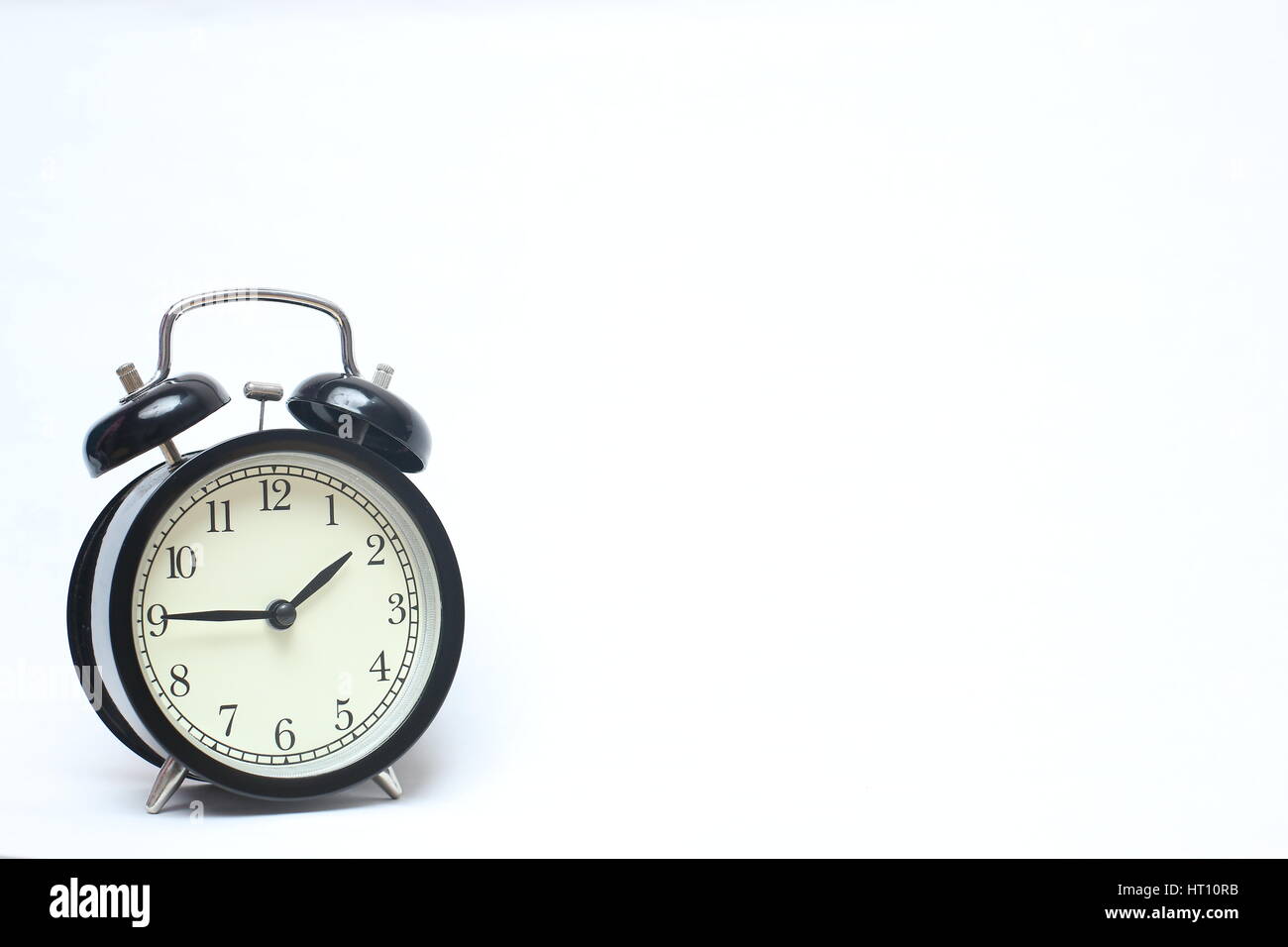Retro alarm clock isolated on white background Stock Photo - Alamy