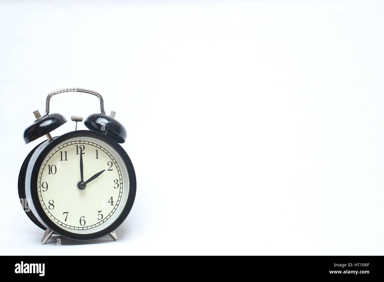 Retro alarm clock isolated on white background Stock Photo - Alamy