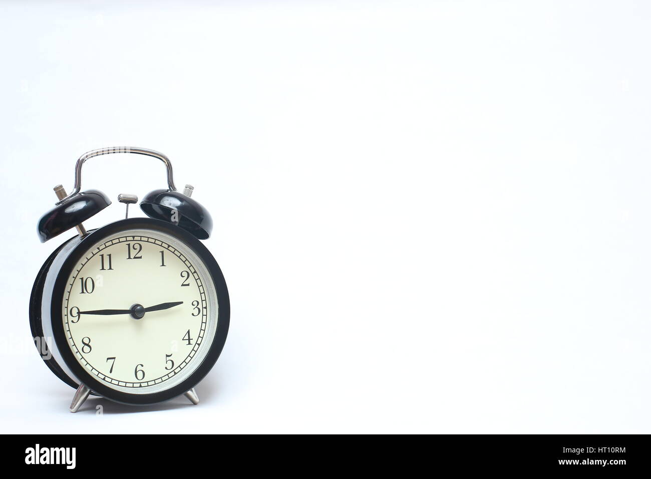 Retro alarm clock isolated on white background Stock Photo - Alamy