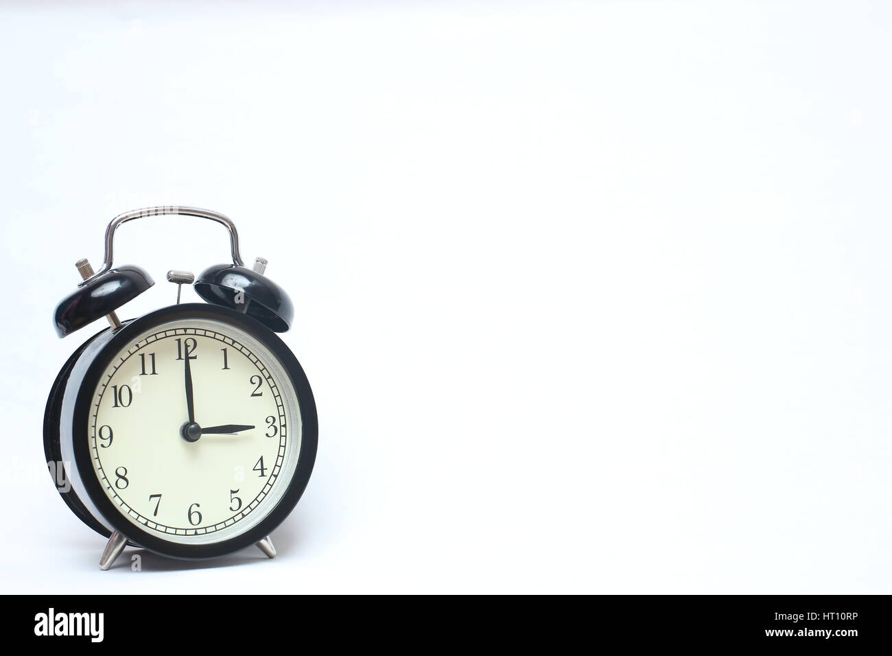 Retro alarm clock isolated on white background Stock Photo - Alamy