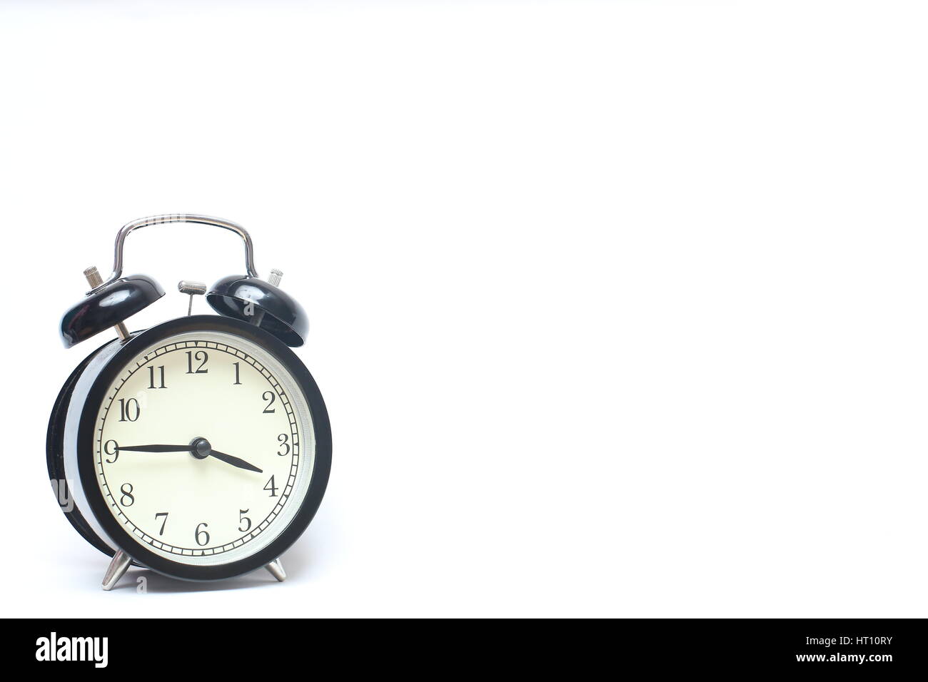 Retro alarm clock isolated on white background Stock Photo - Alamy