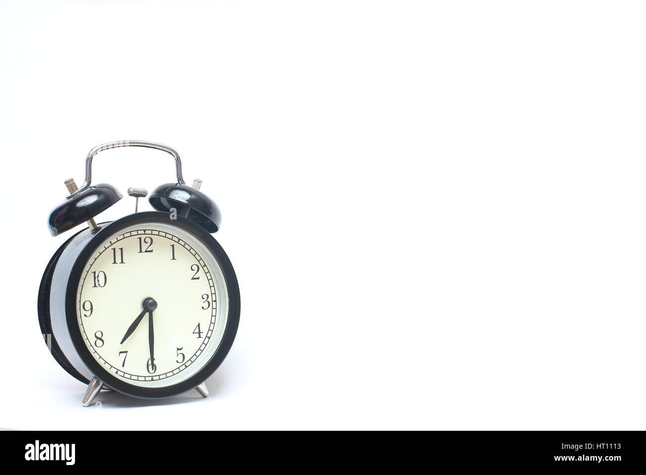 Retro alarm clock isolated on white background Stock Photo - Alamy