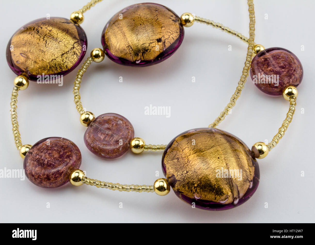 Glass - Murano gold bead necklace close up on white background Stock Photo