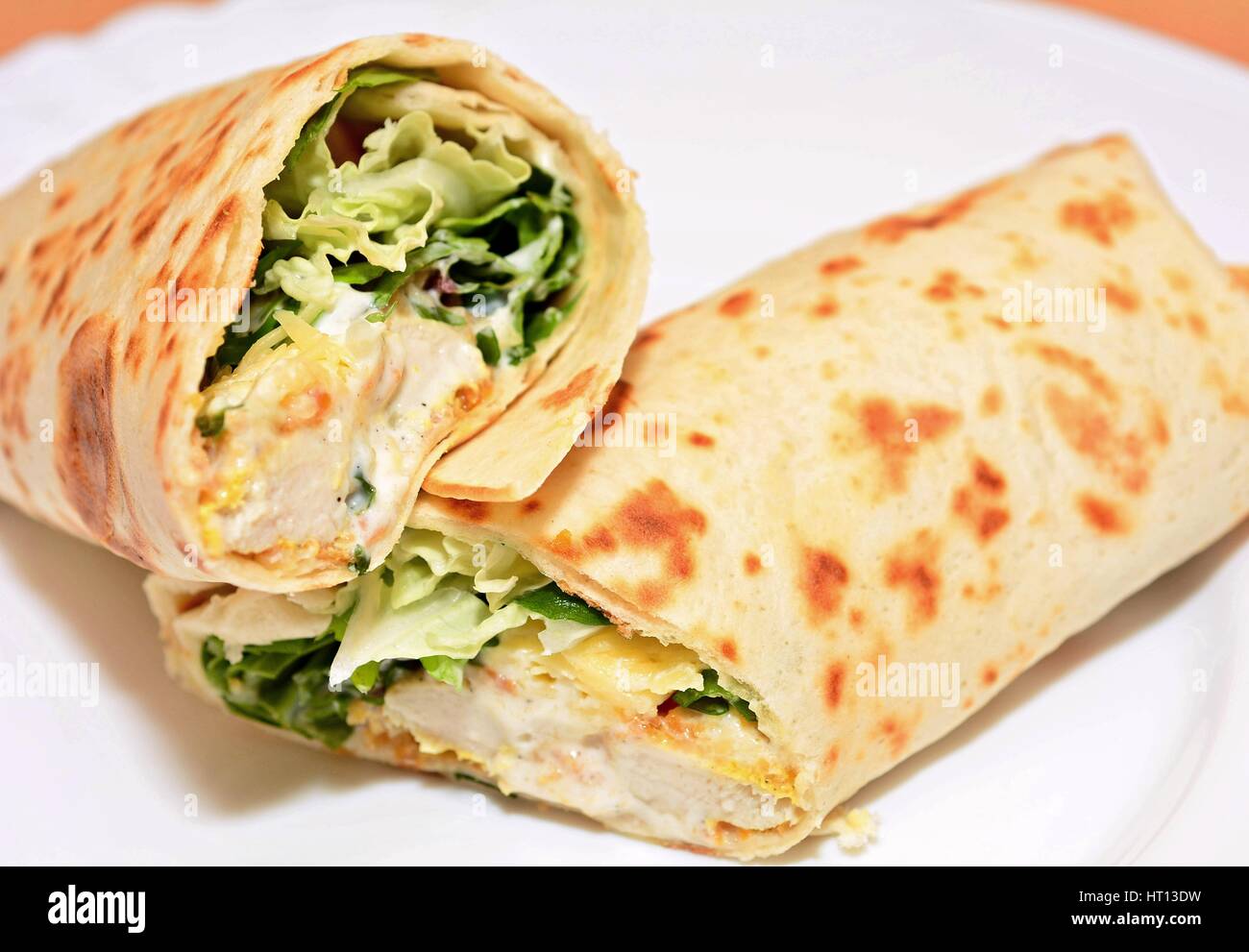 Tortilla wraps with chicken nuggets, fresh vegetable and salad Stock