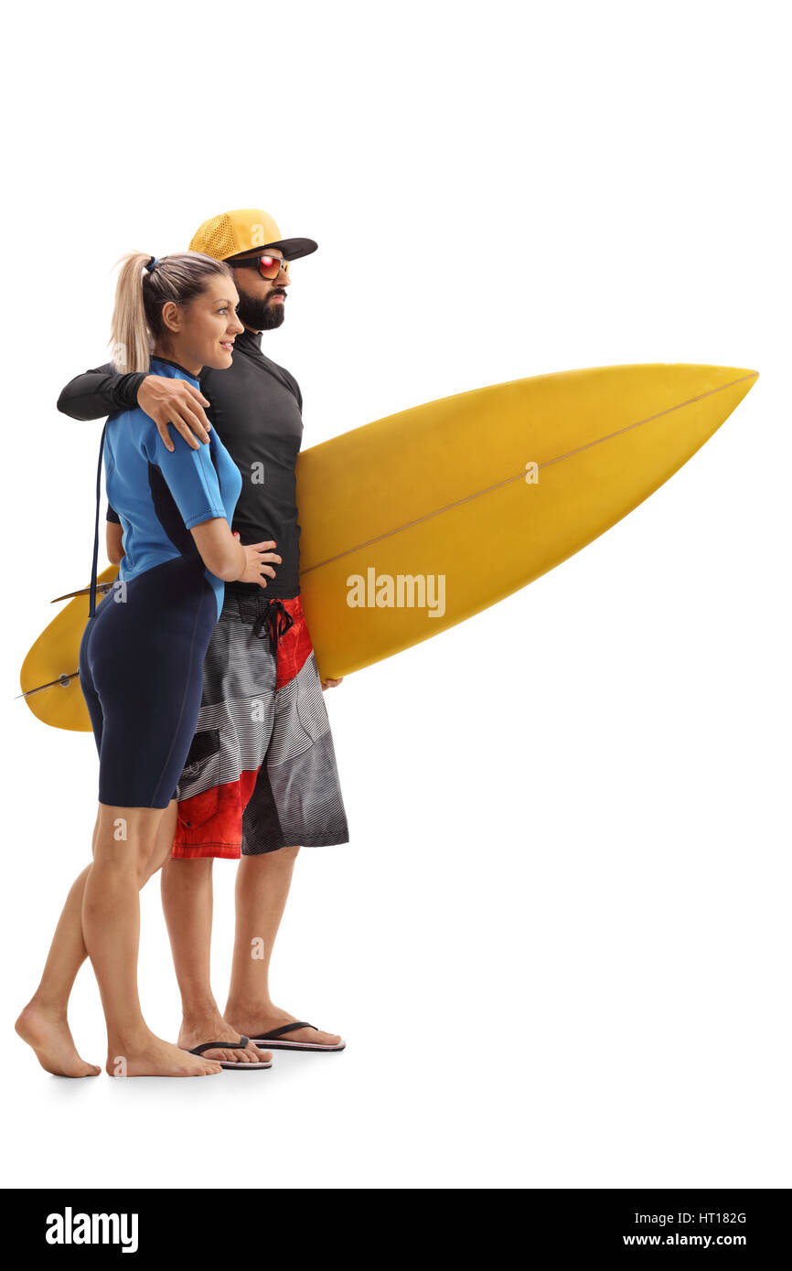 Full length profile shot of a female and a male surfer with a surfboard isolated on white background Stock Photo