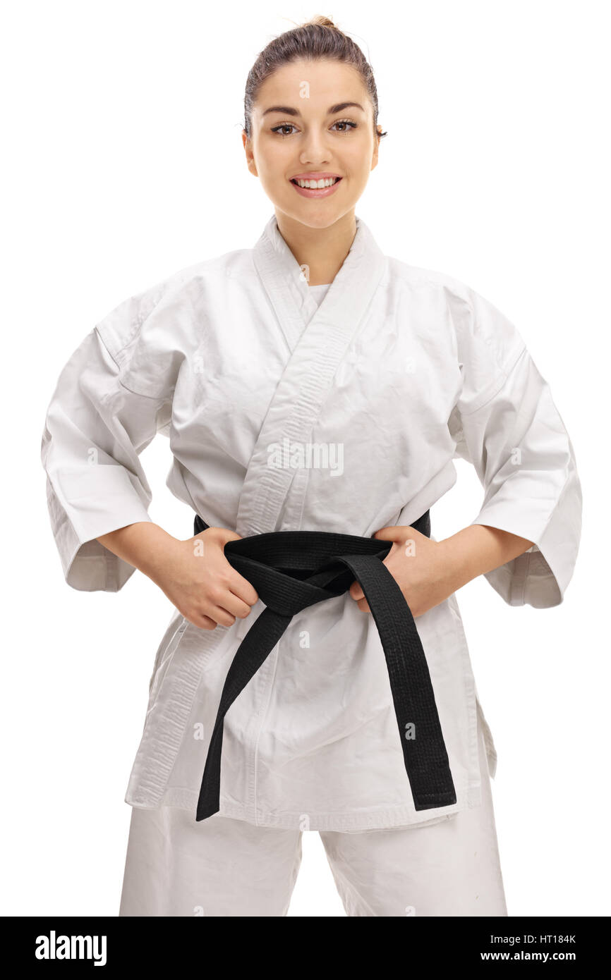 Young girl wearing a kimono with a black belt smiling and looking at the camera isolated on white background Stock Photo