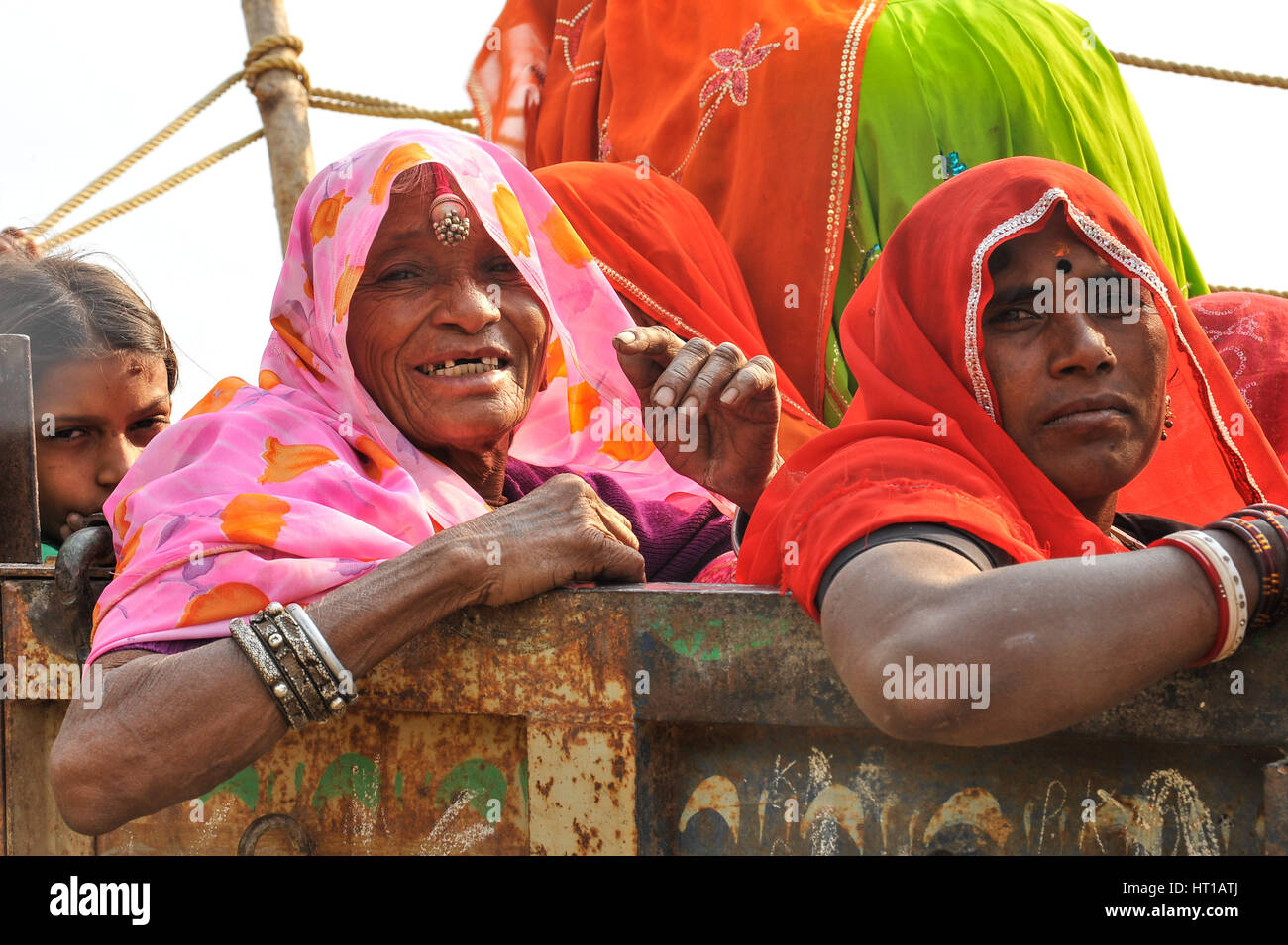 Rajasthani women ride on a trailer (pulled by a tractor) Stock Photo