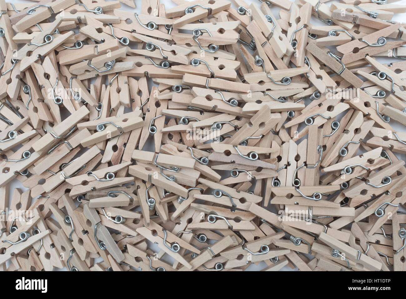 Macro photo of wooden mini clothes pegs. Metaphor for currency pegging - chinese yuan to dollar, for example. Stock Photo