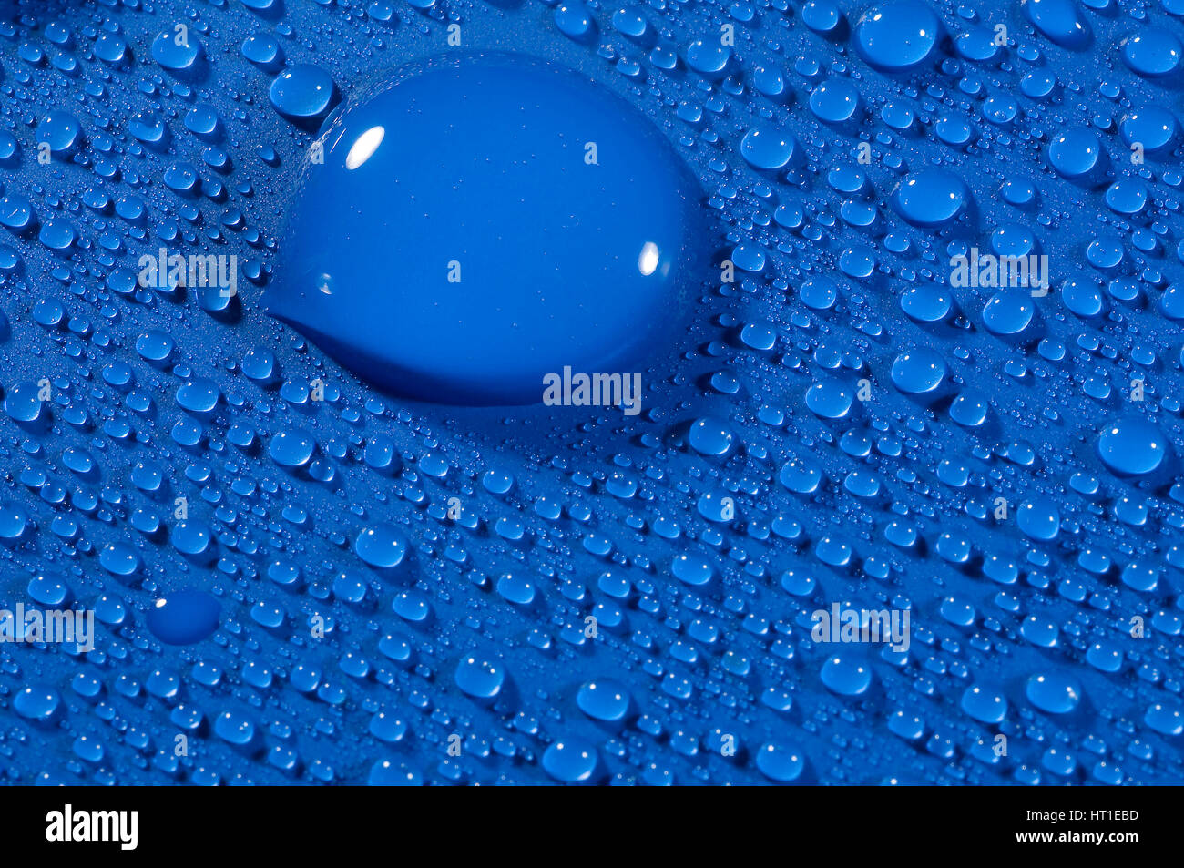 water drops on blue background creating shinny light effect Stock Photo