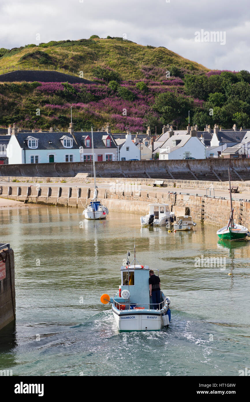 Boat entering harbour at Cullen in Banffshire Stock Photo
