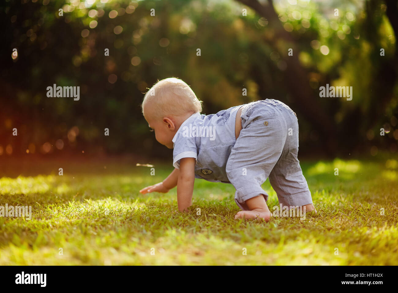 child crawl on green grass Stock Photo - Alamy