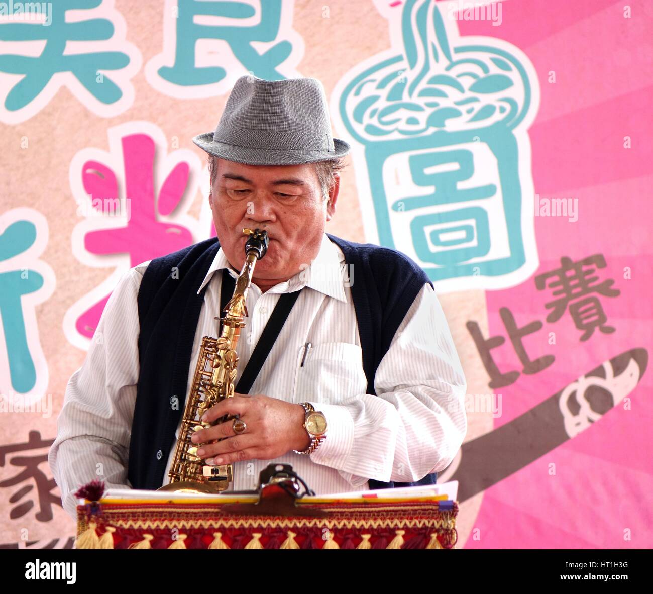 KAOHSIUNG, TAIWAN -- NOVEMBER 28, 2015: An unidentified local musician plays the saxophone at the 2015 Hakka Food Festival, which is a yearly public o Stock Photo