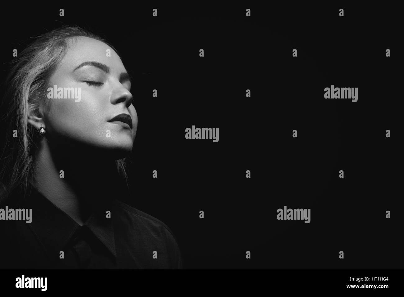 sad woman with closed eyes on black background, monochrome Stock Photo ...