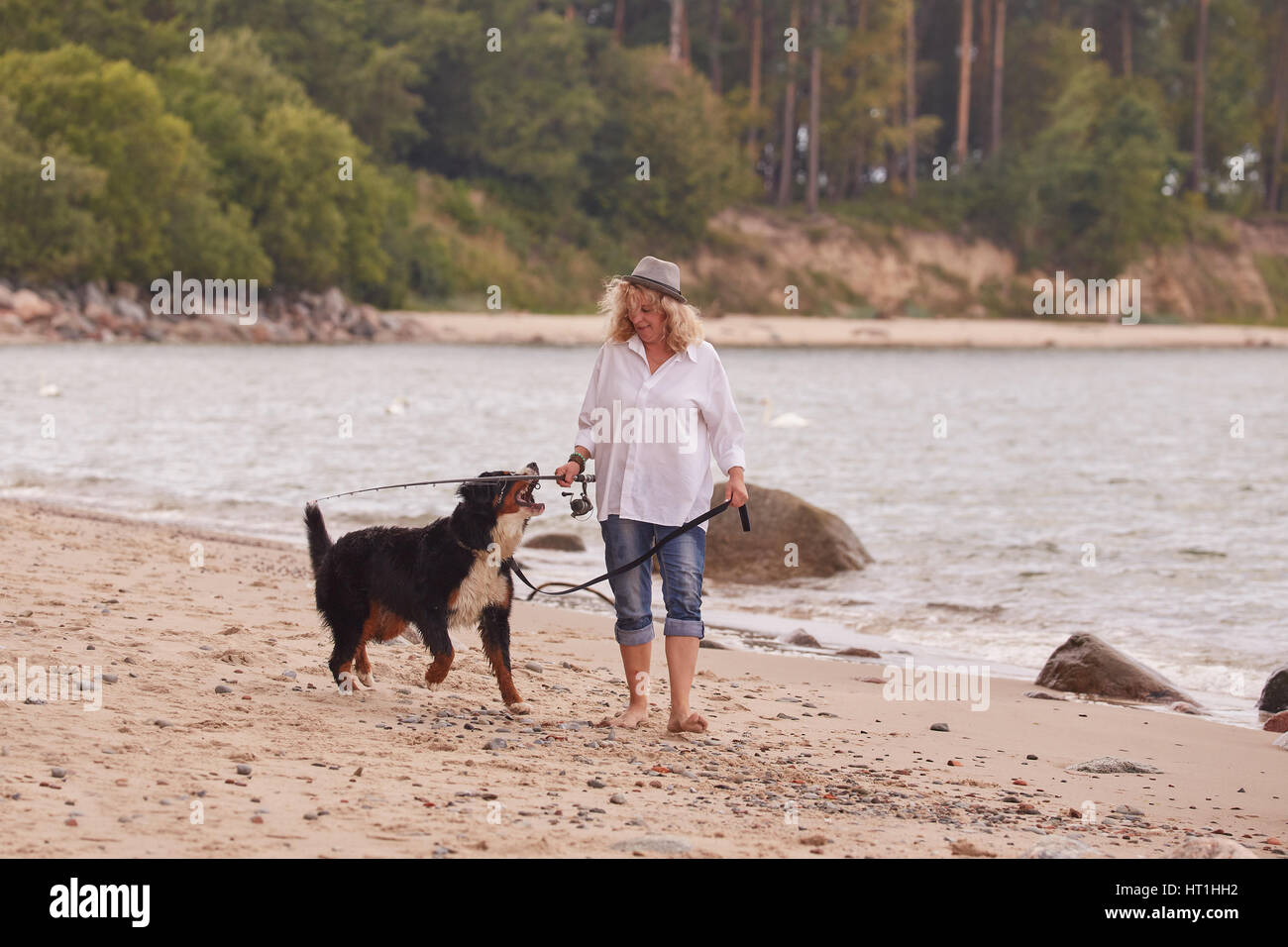 Mature woman dog walking beach hi-res stock photography and images - Alamy
