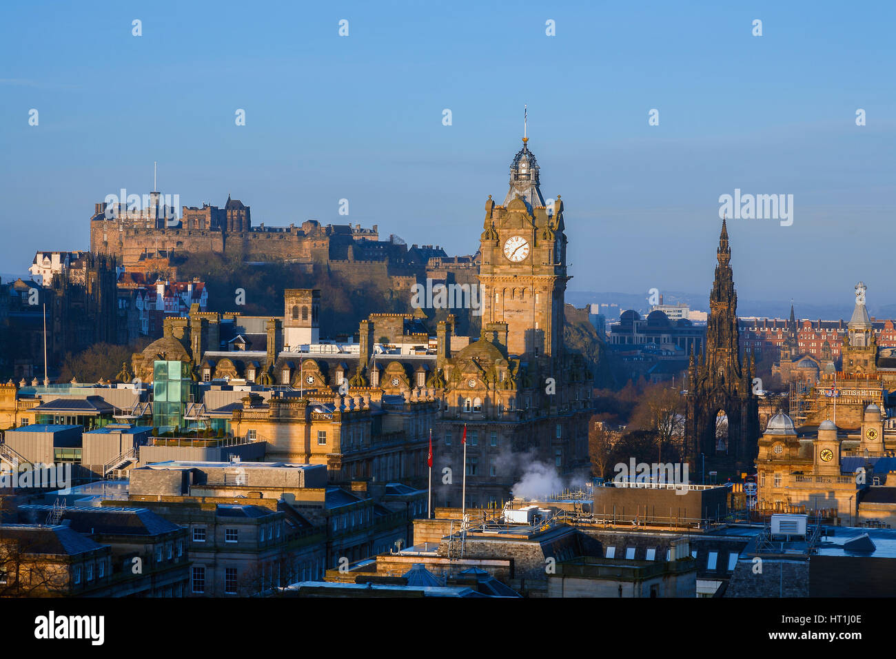 Skyline of Edinburgh at sunrise including the sites Edinburgh Castle, Balmoral Hotel Clock Tower and the Scott monument. Stock Photo
