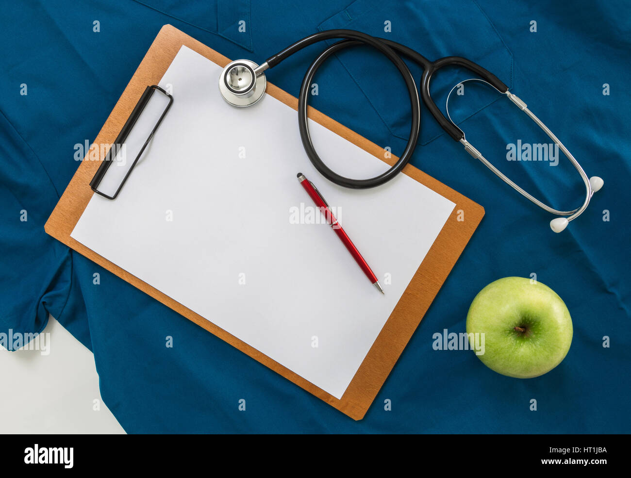 Clipboard with stethoscope on doctor's shirt. Stock Photo