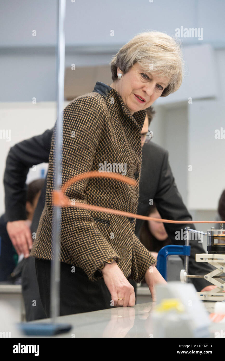 Prime Minister Theresa May observes a physics experiment alongside Head Teacher Dan Abramson during a visit to King's College London Mathematics School in central London as more than half a billion pounds is to be pumped into creating new free schools, including grammars, and refurbishing existing school buildings, the Government has said. Stock Photo