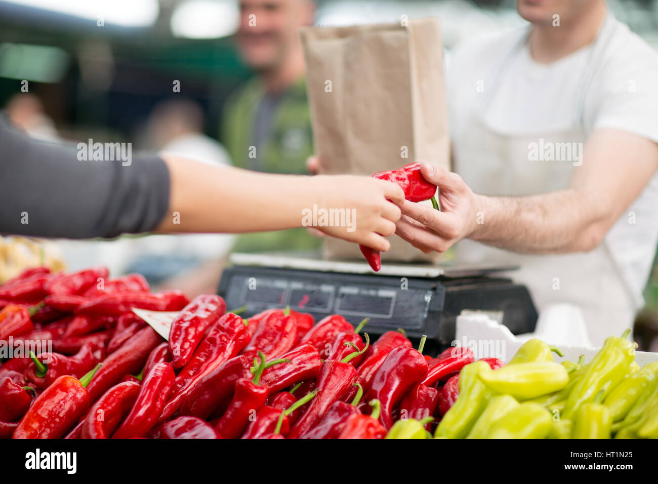 measuring red pepper at the market Stock Photo - Alamy
