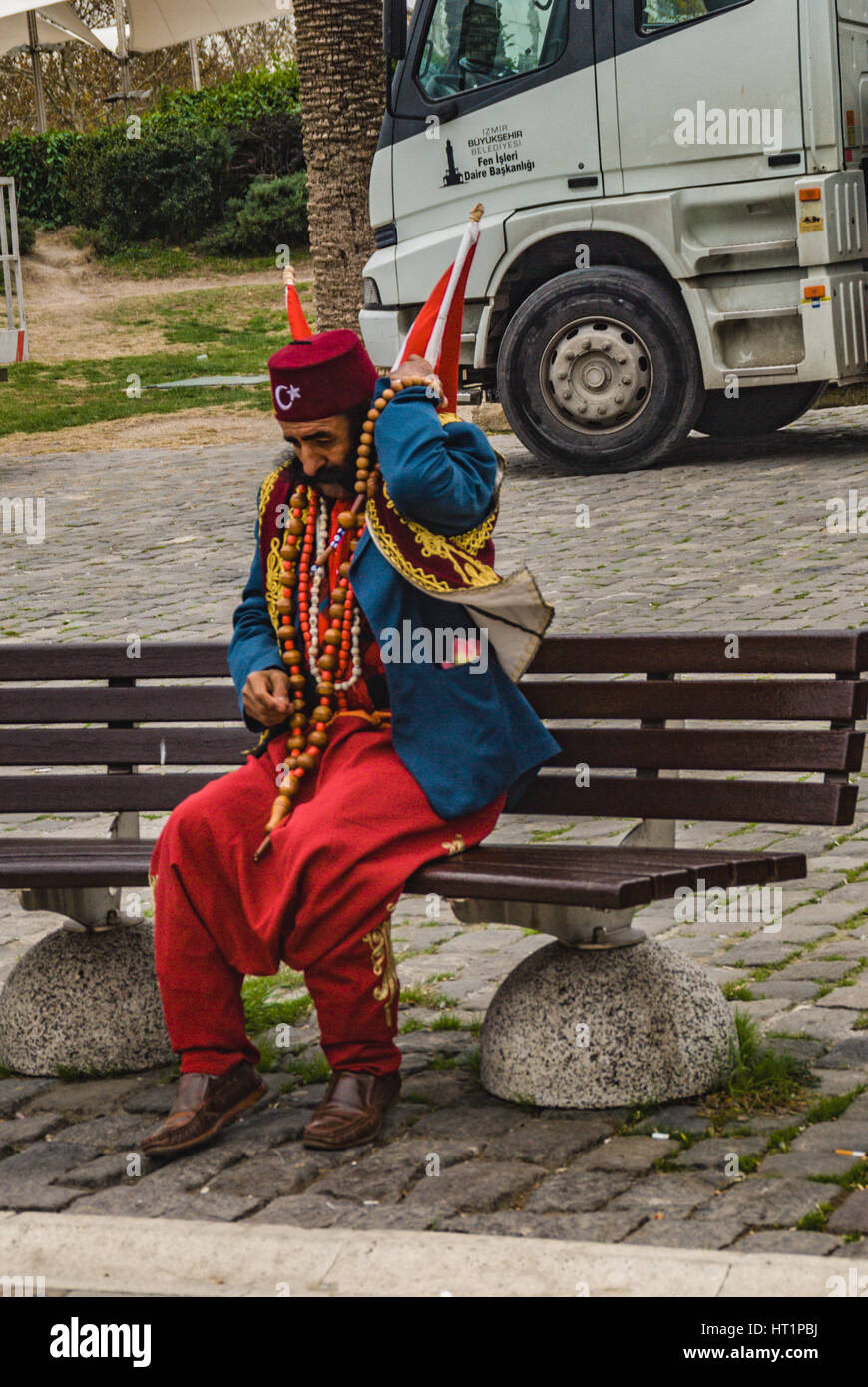 interesting costume man sitting in the park in izmir in old ottoman and turkish clothes Stock Photo