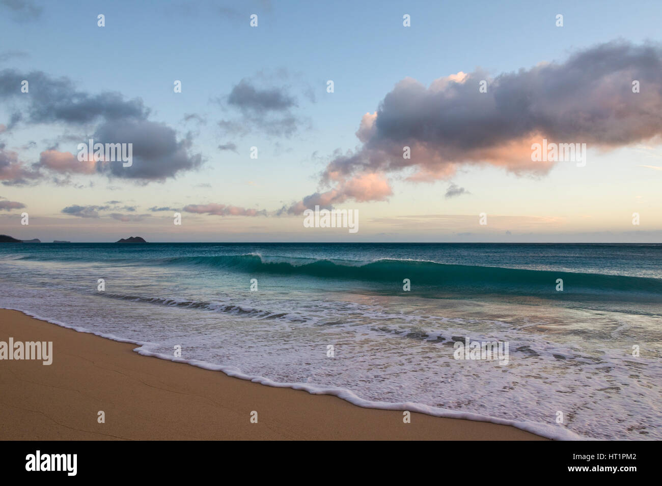 A wave breaking at sunrise, Waimanalo beach park, Oahu Stock Photo Alamy
