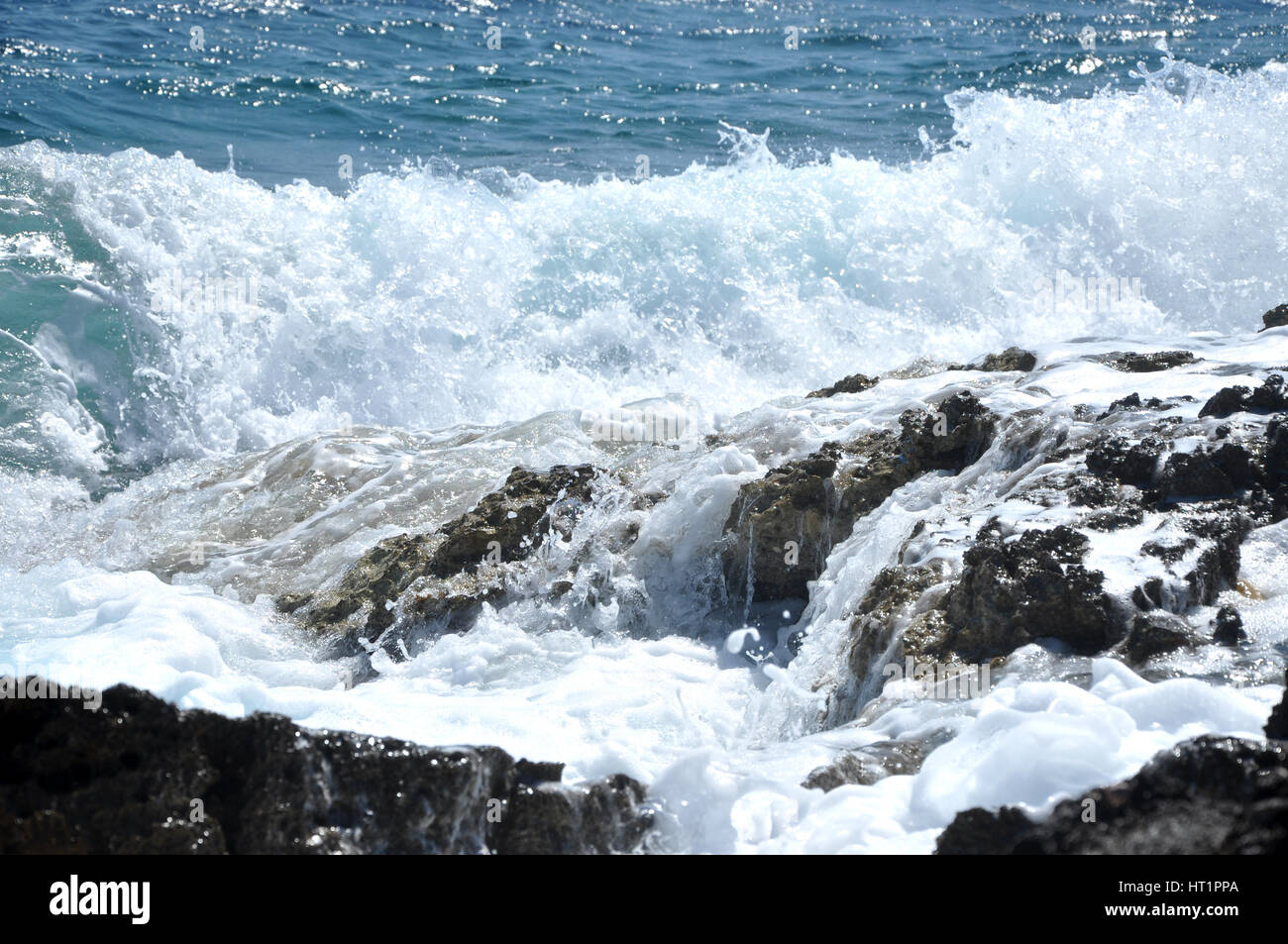 Splashing sea wave in a rocky coastline Stock Photo - Alamy