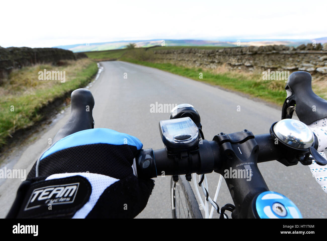 Cycling along a quite country lane low angle of the cyclist handlebars Stock Photo