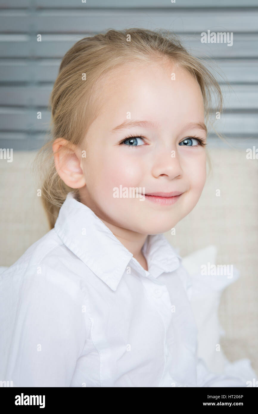Adorable blond preschool girl portrait, smiling child, candid natural portrait Stock Photo