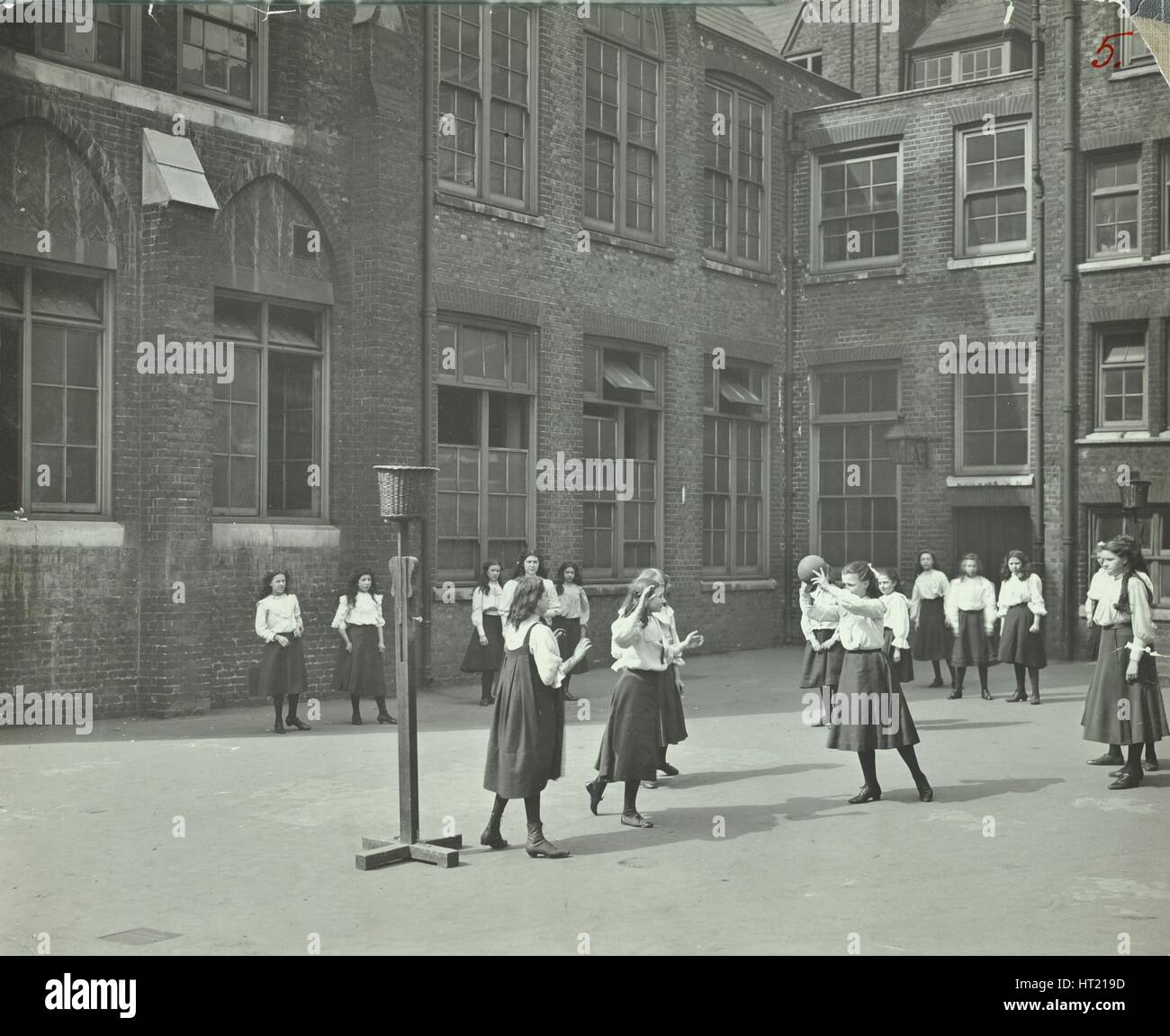 Girls playing netball in the playground, William Street Girls School, London, 1908. Artist: Unknown. Stock Photo