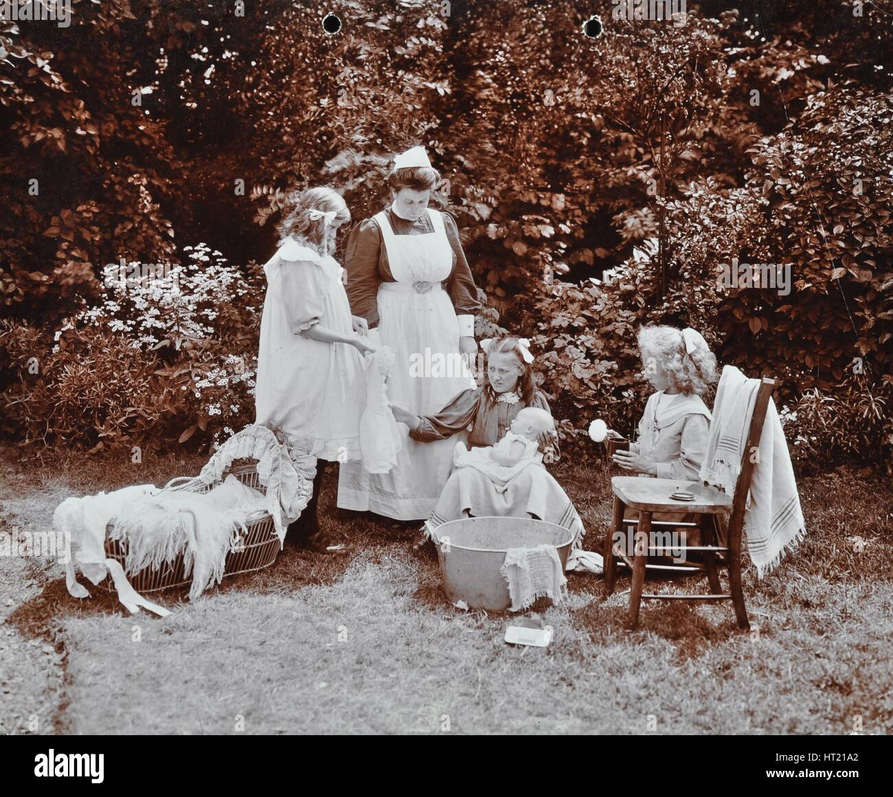 Girls learning infant care, Birley House Open Air School, Forest Hill, London, 1908. Artist: Unknown. Stock Photo