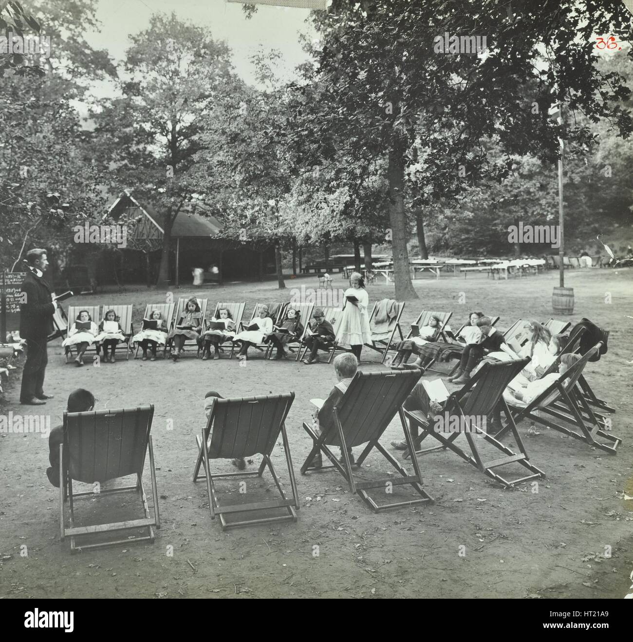 Reading lesson outside, Bostall Woods Open Air School, London, 1907. Artist: Unknown. Stock Photo