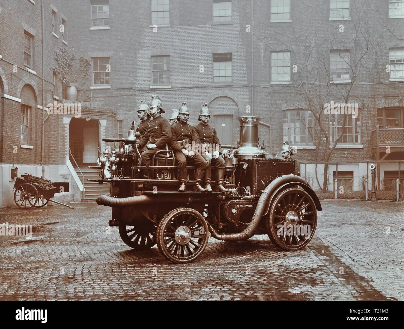 Firemen aboard a motor steamer, London Fire Brigade Headquarters, London, 1909. Artist: Unknown. Stock Photo