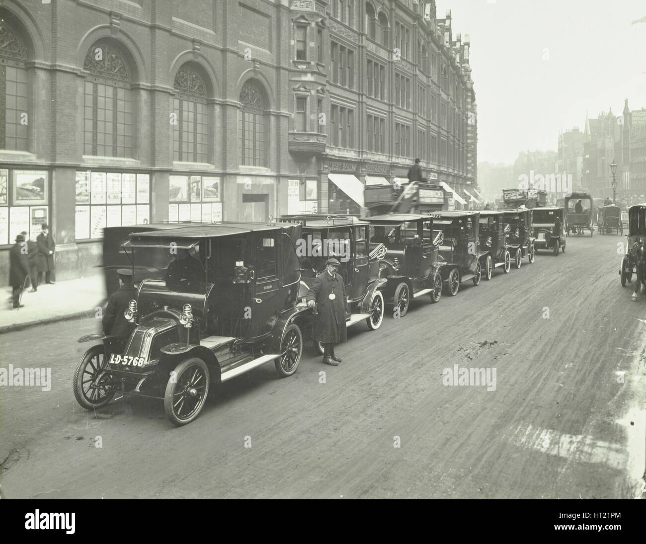 Hackney carriages and drivers at a taxi rank, Bishopsgate, London, 1912. Artist: Unknown. Stock Photo