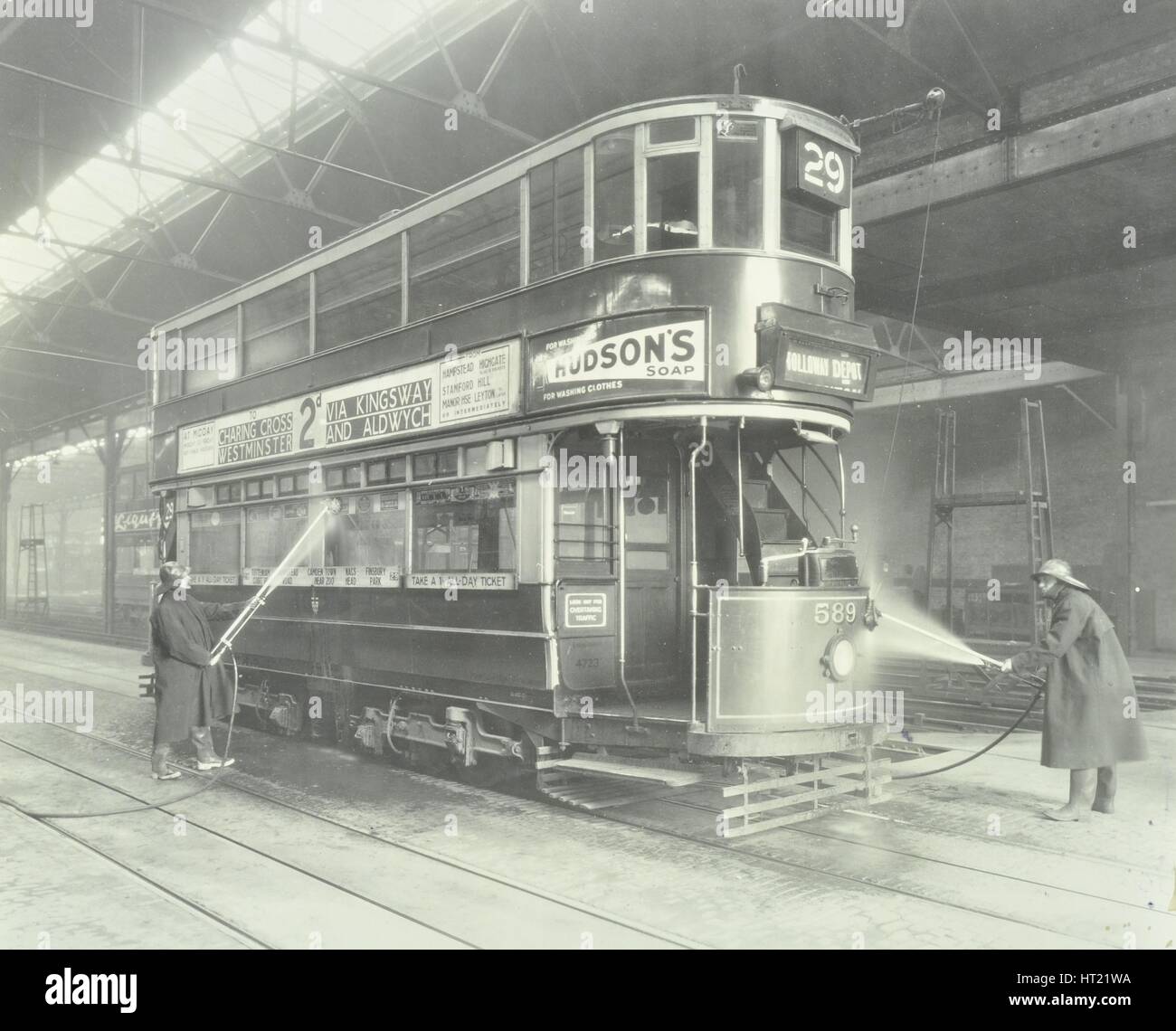 Transport workers washing a tram at the Holloway Car Shed, London, 1932.  Artist: Unknown. Stock Photo