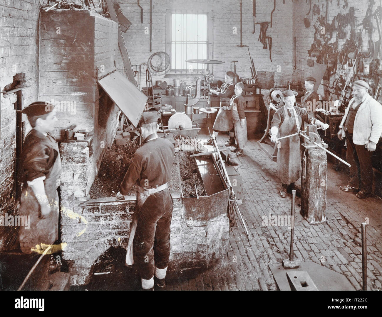 Boys at work in the smith's shop, Feltham Industrial School, London, 1908. Artist: Unknown. Stock Photo