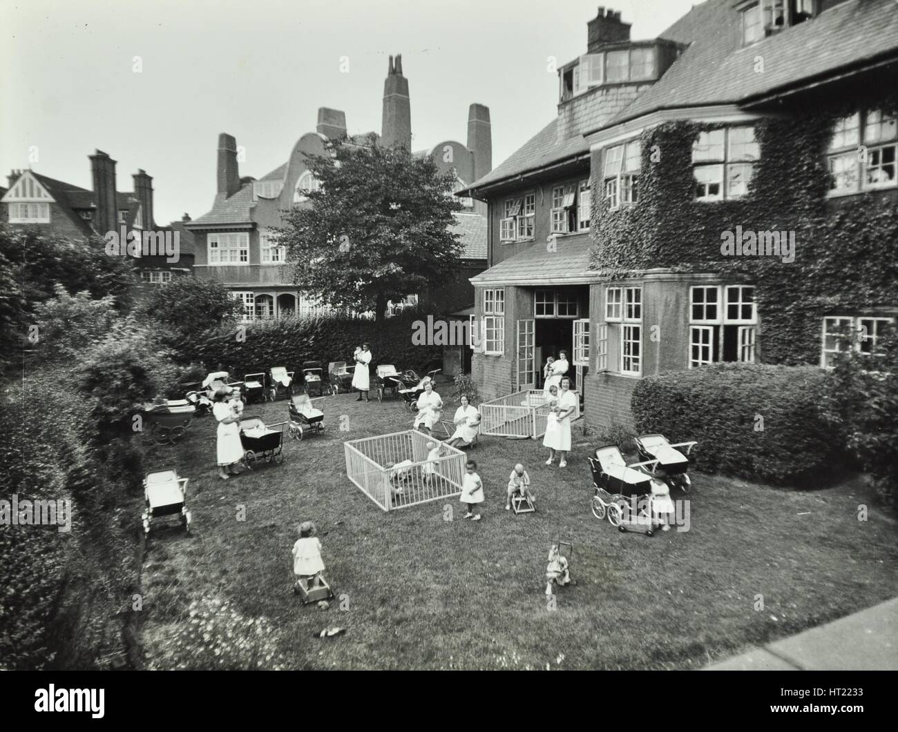 Children and carers in a garden, Hampstead, London, 1960. Artist: Unknown. Stock Photo