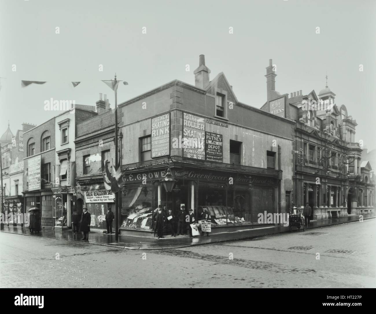 Shops and sign to Putney Roller Skating Rink, Putney Bridge Road, London, 1911. Artist: Unknown. Stock Photo