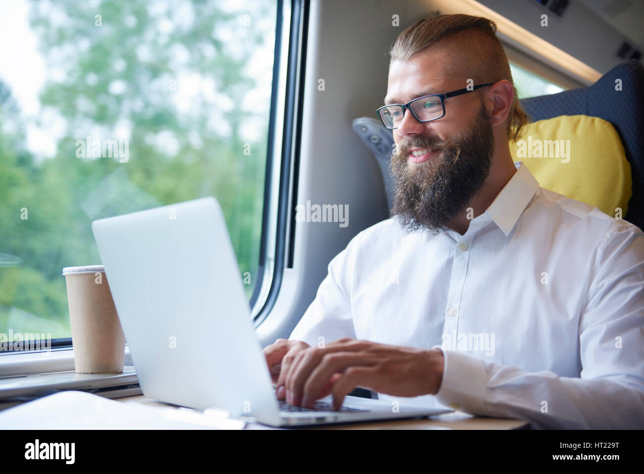 Businessman with beard working during the journey Stock Photo
