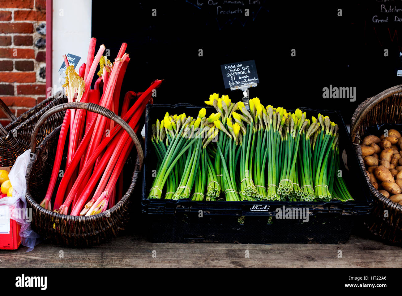 Rhubard and daffodils for sale on country stall, Norfolk, U.K Stock Photo