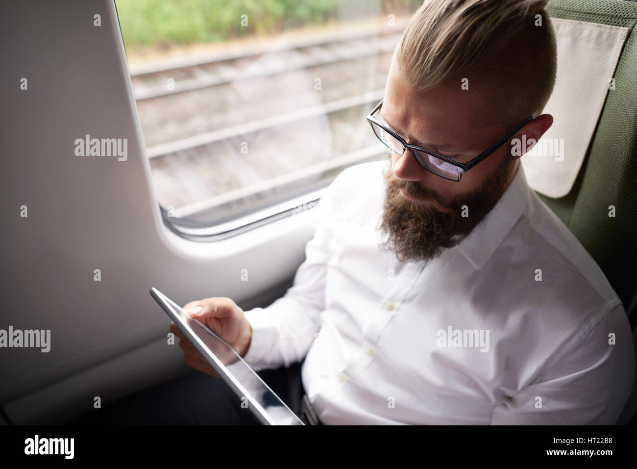 Business with long beard working during the travel Stock Photo