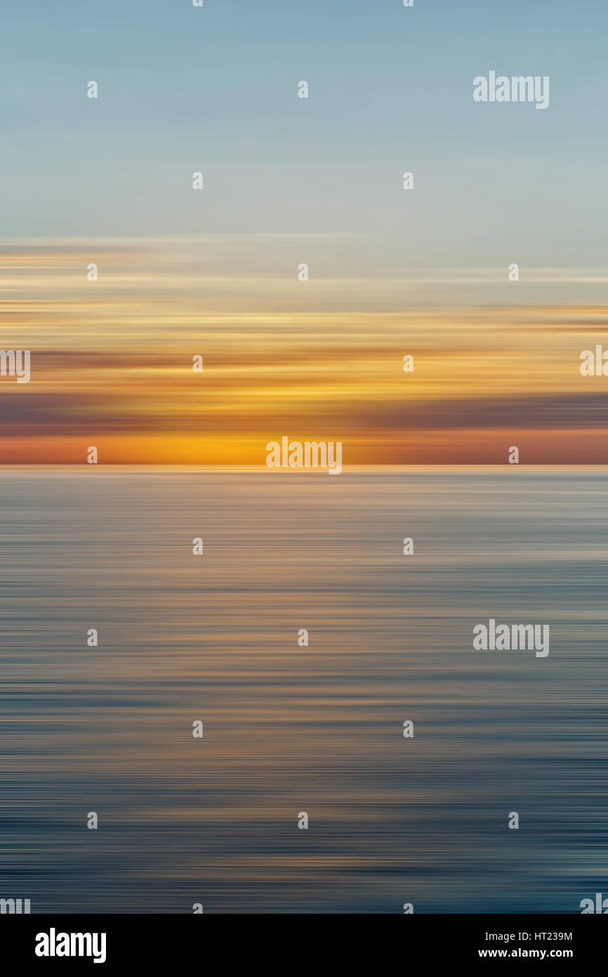 Colorful sunrise with long exposure effect, horizontal motion blurred ...