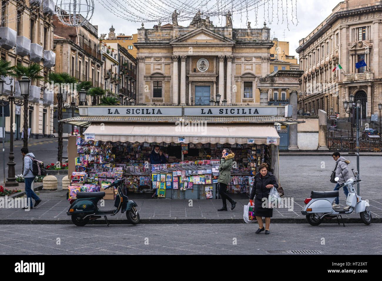 Newsstand on Piazza Stesicoro (Stesicoro Square) in Catania city on the east side of Sicily Island, Italy. San Biagio church on background Stock Photo