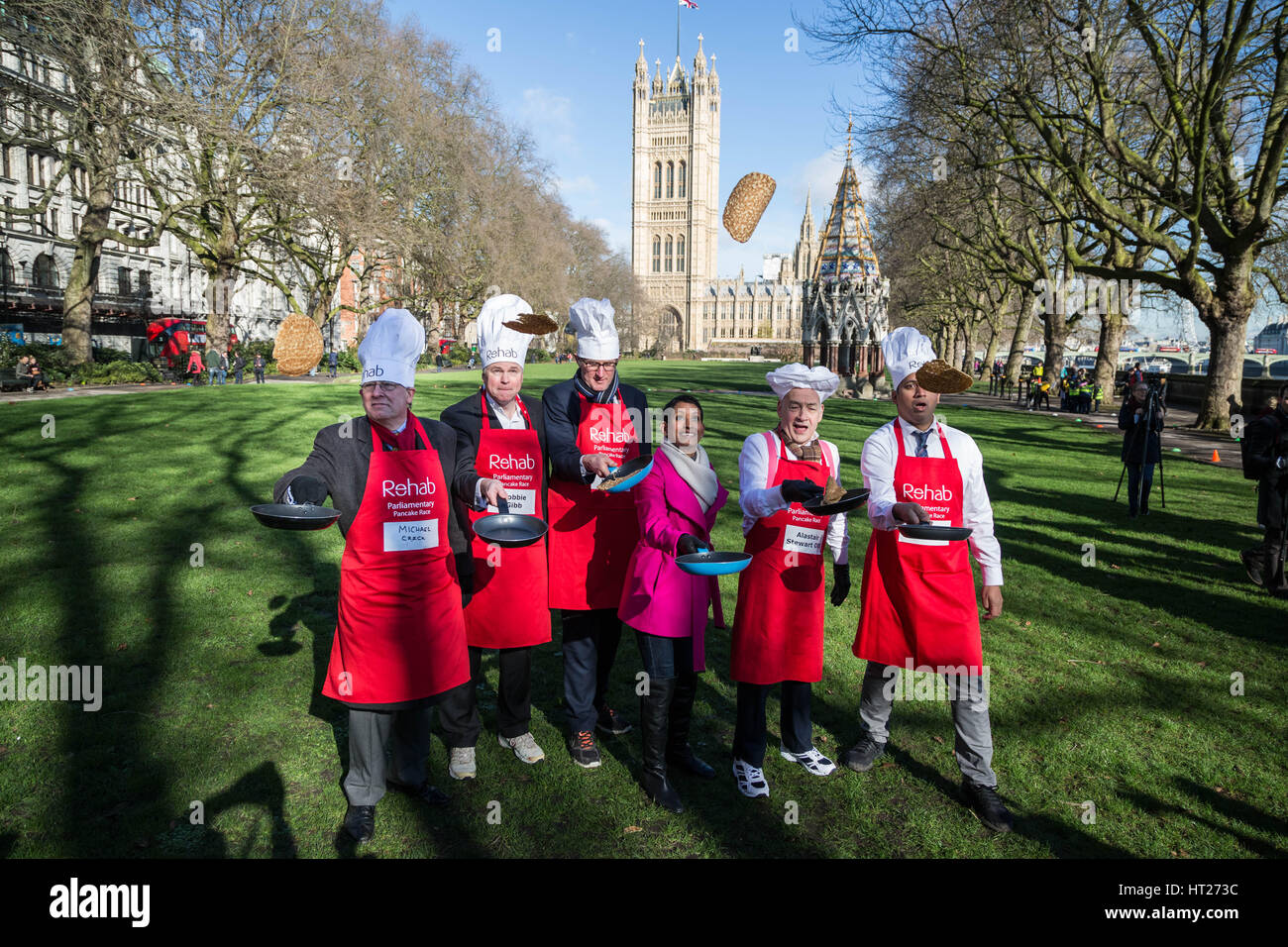 L-R Michael Crick, Robbie Gibb, James Landale, Naga Munchetty, Alastair Stewart and Faisal Islam. MPs, Lords and Media attend the 20th Annual Rehab Parliamentary Pancake Race at Victoria Gardens in Westminster, London, UK. Stock Photo