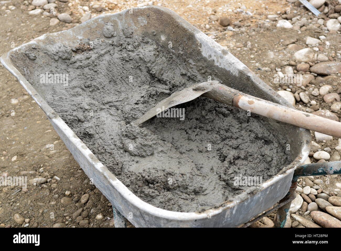 Wheelbarrow with shovel full of cement Stock Photo Alamy