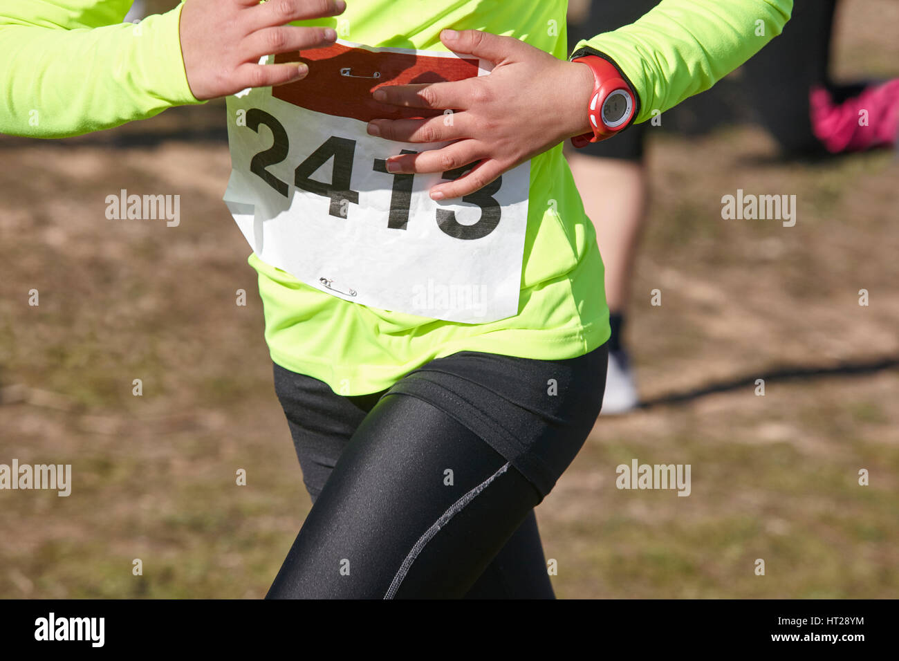 Junior athletics runner on a cross country race. Outdoor circuit. Horizontal Stock Photo