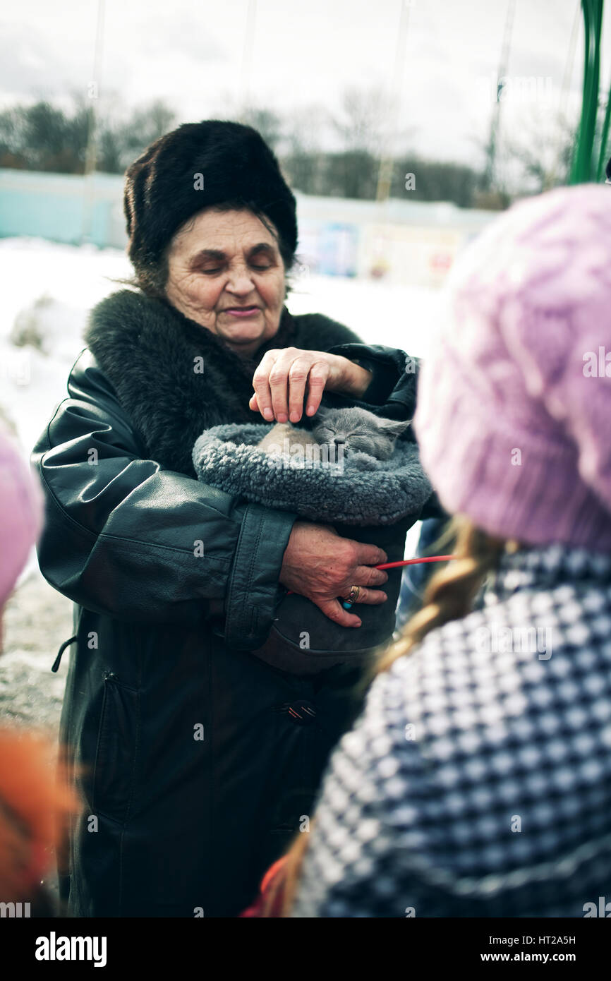 Russian lady carrying small cat in bag hires stock photography and