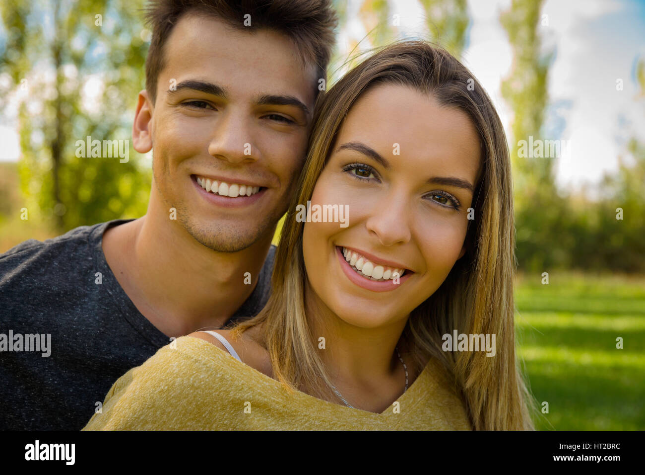 Portrait of a young beautiful couple smiling Stock Photo - Alamy